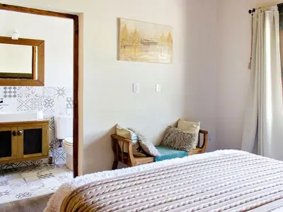 a bedroom with a bed and a mirror at Cabañas San Javier in Pueblito