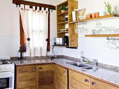 a kitchen with a sink and a stove at Cabañas San Javier in Pueblito