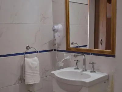 a bathroom with a sink and a mirror at Cabañas San Javier in Pueblito