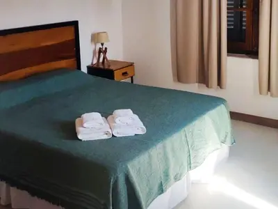 a bedroom with a bed with two towels on it at Cabañas San Javier in Pueblito
