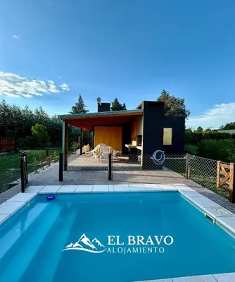 a swimming pool in front of a house at El Bravo Alojamiento in Villa Rumipal