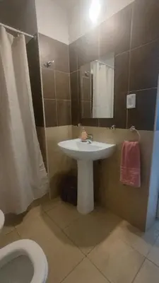 a bathroom with a sink and a toilet at Anicca Alberdi Córdoba Centro in Cordoba