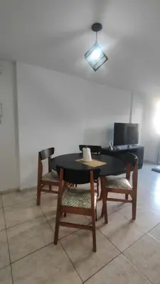 a dining room table with two chairs and a laptop at Anicca Alberdi Córdoba Centro in Cordoba