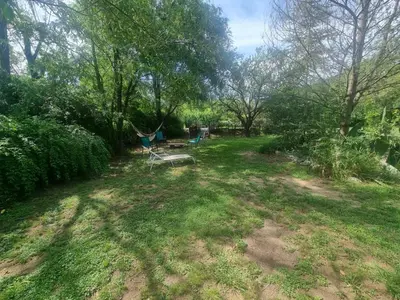an empty yard with a hammock and trees at Duplex Las Violetas in Merlo