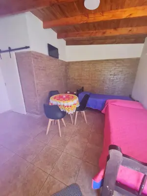 a room with a table and chairs and a bed at Dálet in Villa Parque Siquiman