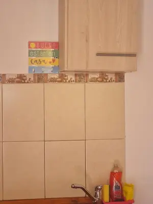 a kitchen counter with a sink and a sign on the wall at Dálet in Villa Parque Siquiman