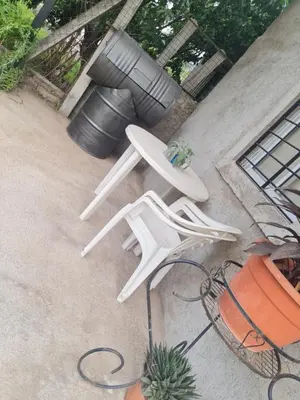 two white lawn chairs sitting on a patio at Dálet in Villa Parque Siquiman
