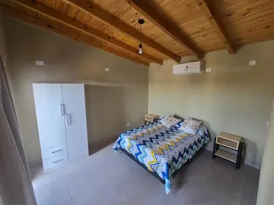 a bedroom with a bed and a wooden ceiling at Gaviotas del Sur in Potrero de Garay