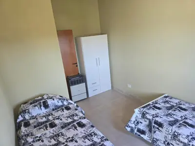 a living room with a couch and a refrigerator at Gaviotas del Sur in Potrero de Garay