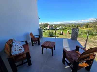 a room with chairs and a table and a view at Gaviotas del Sur in Potrero de Garay
