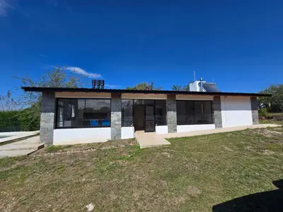 a house on top of a grassy field at Gaviotas del Sur in Potrero de Garay