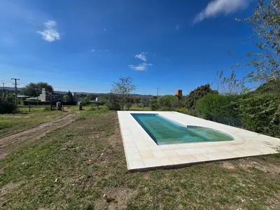a swimming pool in the middle of a field at Gaviotas del Sur in Potrero de Garay