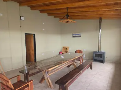 a dining room with a large wooden table and chairs at Gaviotas del Sur in Potrero de Garay