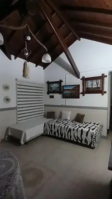 a bedroom with a black and white bed in a room at CASA TODA EN PLANTA BAJA CON PARQUE y PILETA INDIVIDUAL SOBRE ASFALTO A POCAS CUADRAS DEL CENTRO DE MERLO in Merlo