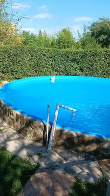 a swimming pool with a blue water at CASA TODA EN PLANTA BAJA CON PARQUE y PILETA INDIVIDUAL SOBRE ASFALTO A POCAS CUADRAS DEL CENTRO DE MERLO in Merlo
