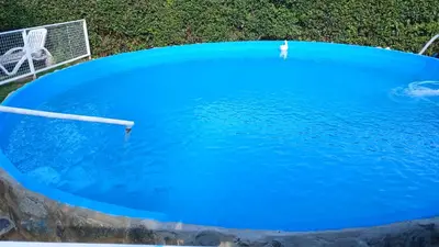 a blue pool of water with two paddles in it at CASA TODA EN PLANTA BAJA CON PARQUE y PILETA INDIVIDUAL SOBRE ASFALTO A POCAS CUADRAS DEL CENTRO DE MERLO in Merlo