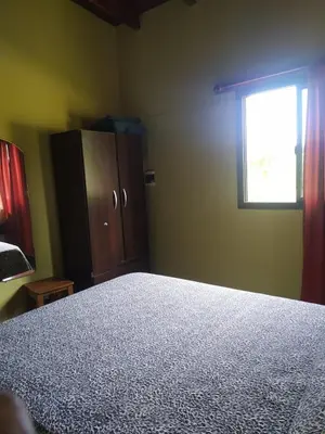 a bedroom with a bed and a window at Cabañas Tanti in Tanti