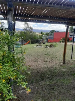 a park with a playground with a picnic table and swings at Cabañas Tanti in Tanti