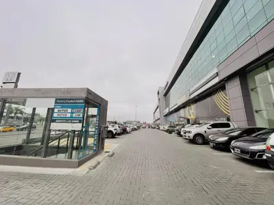 a parking lot with cars parked next to a building at Departamento Complejo Ciudad Gama in Cordoba