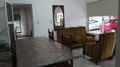 a living room with a table and a couch at Las vasijas in Villa Amancay