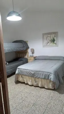 a bedroom with two beds and a lamp at Las vasijas in Villa Amancay