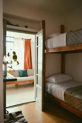 a room with two bunk beds and a window at Hostel céntrico Casa Revol in Cordoba