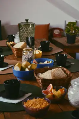 a wooden table with bowls of food on it at Hostel céntrico Casa Revol in Cordoba