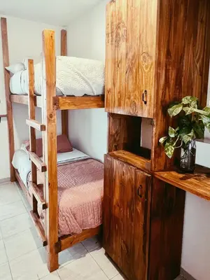 a room with two bunk beds and a cabinet at Hostel céntrico Casa Revol in Cordoba