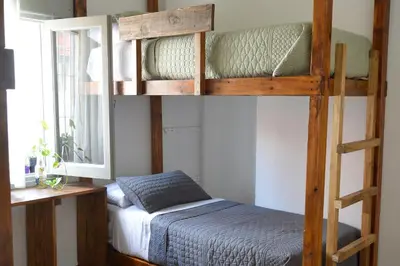 a bedroom with two bunk beds and a bed at Hostel céntrico Casa Revol in Cordoba
