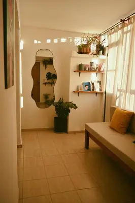 a living room with a couch and a mirror on the wall at Hostel céntrico Casa Revol in Cordoba