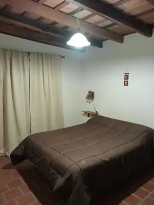 a bedroom with a large bed in a room at Cabañas Pedras Moras in Tanti