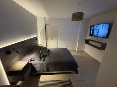a bedroom with a bed and a flat screen tv at Alberdi Urbano in Cordoba