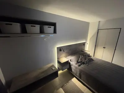 a bedroom with a bed and a mirror and lights at Alberdi Urbano in Cordoba
