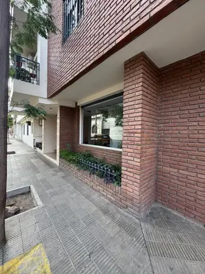 a brick wall next to a building with a window at Alberdi Urbano in Cordoba