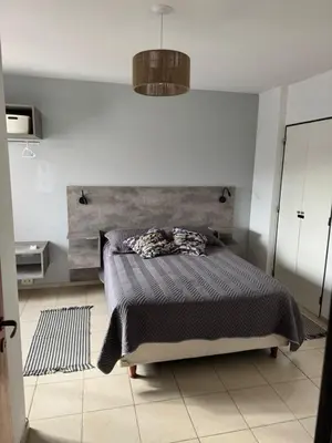 a bedroom with a bed with a wooden headboard at Alberdi Urbano in Cordoba