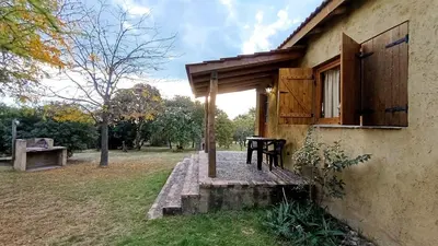 a porch of a house with a table outside at Las Acacias Suites in Las Rabonas