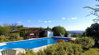a swimming pool in the garden of a villa at Las Acacias Suites in Las Rabonas