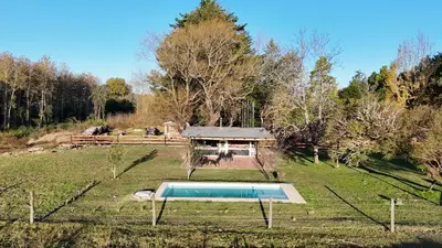 a house with a pool in the middle of a field at Real del Cóndor San Clemente in San Clemente