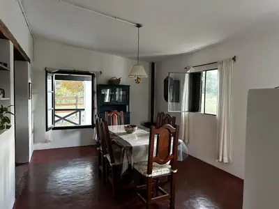 a dining room with a table and chairs at Real del Cóndor San Clemente in San Clemente