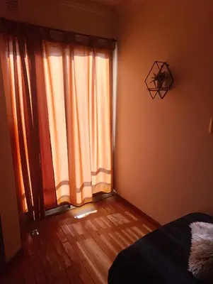 a bedroom with a large window and a wooden floor at Nueva Córdoba Ambrosio Olmos 898 pleno bv a metros de plaza España la universidad clínicas gastronomía etc etc in Cordoba