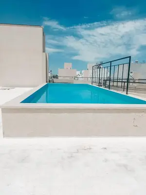 an empty swimming pool on top of a building at Dpto zona Clínica REINA FABIOLA con pileta in Cordoba
