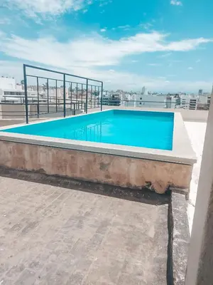 a swimming pool on the roof of a building at Dpto zona Clínica REINA FABIOLA con pileta in Cordoba