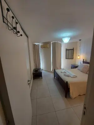 a bedroom with a large bed and a room with at Dpto zona Clínica REINA FABIOLA con pileta in Cordoba