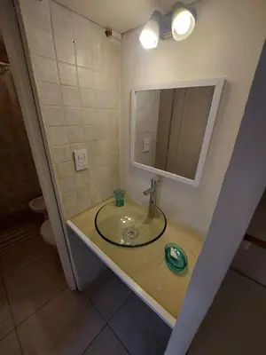 a bathroom with a sink and a mirror at Dpto zona Clínica REINA FABIOLA con pileta in Cordoba
