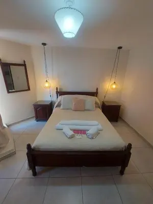 a bedroom with a bed with two towels on it at Dpto zona Clínica REINA FABIOLA con pileta in Cordoba