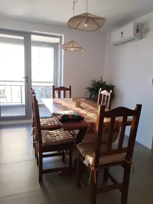 a dining room table and chairs in a room at Depto 2 dormitorios a estrenar, amplio y luminoso in Cordoba