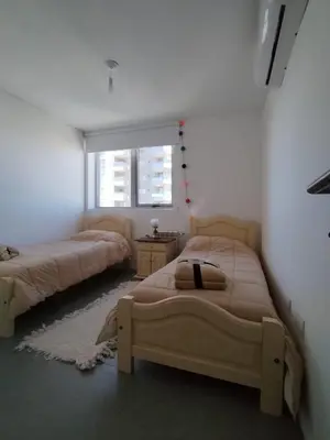 a bedroom with two beds and a window at Depto 2 dormitorios a estrenar, amplio y luminoso in Cordoba