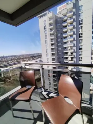 two chairs on a balcony with a view of a city at Depto 2 dormitorios a estrenar, amplio y luminoso in Cordoba
