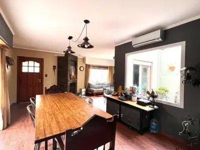 a kitchen with a wooden table and a dining room at Casa alojamiento in Cordoba