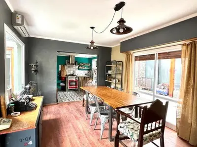 a dining room with a wooden table and chairs at Casa alojamiento in Cordoba